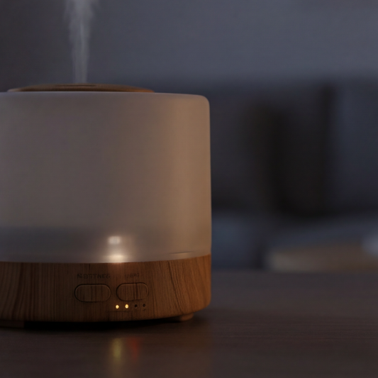 White and wooden diffuser emitting mist on a blurred background