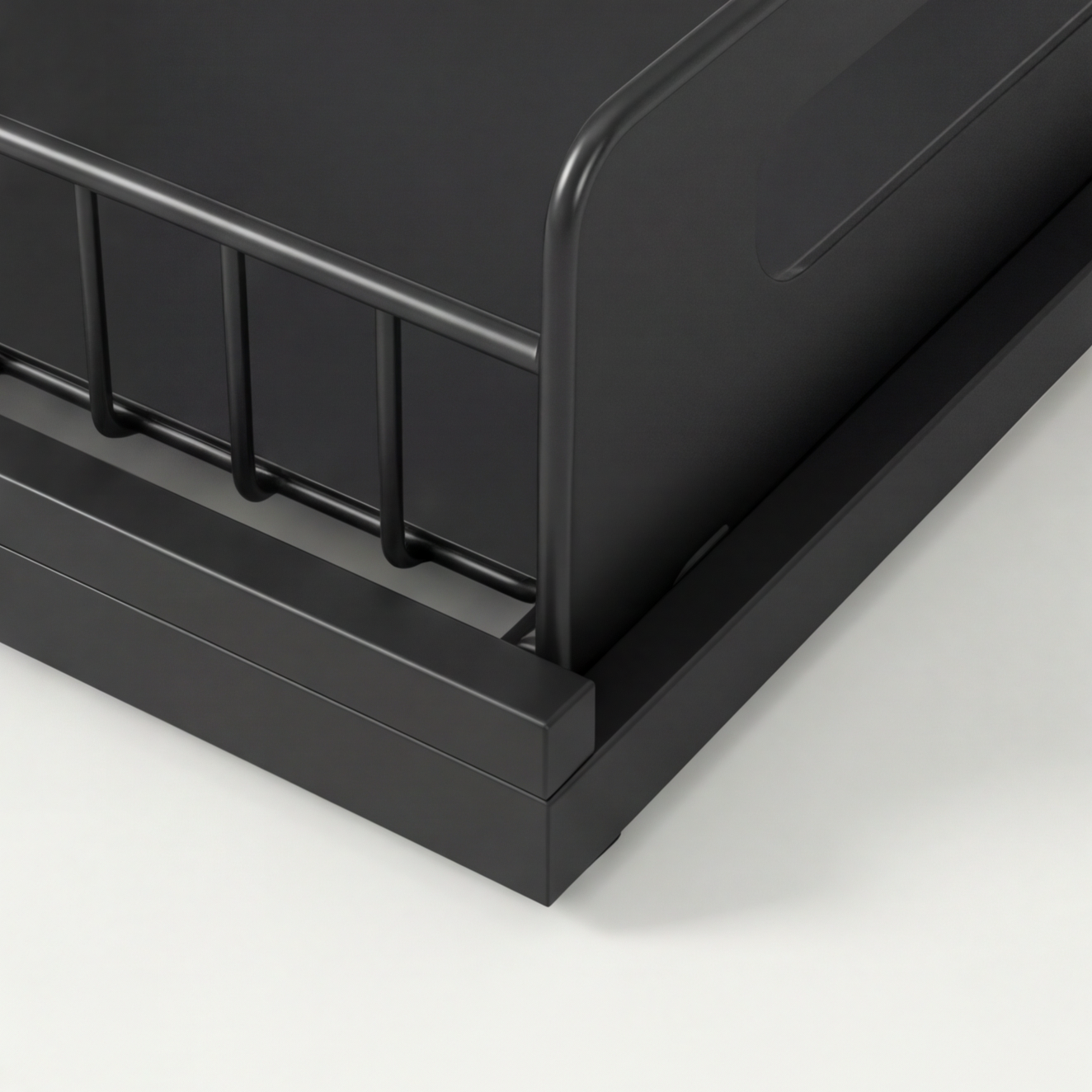 Close-up of a black metal bed frame on a white background